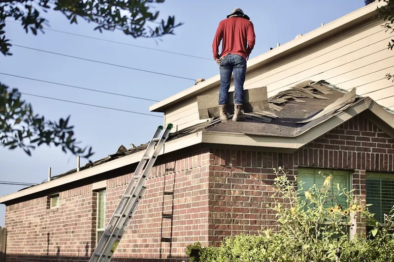 Professional roofer working on a residential roof in Narnia